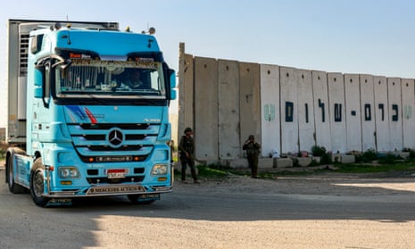 A truck carrying humanitarian aid moves at the Israeli side of the Kerem Shalom border crossing with southern Gaza