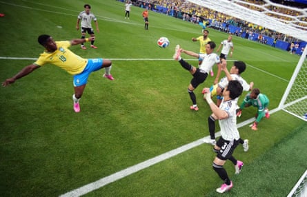 Brazil’s Endrick flings his boot at a loose ball as Japan’s players scramble to clear their lines.