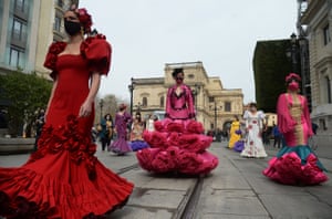Models and dancers dressed in flamenco dresses march during a protest to shed light on the difficulties the flamenco sector is facing over coronavirus restrictions.