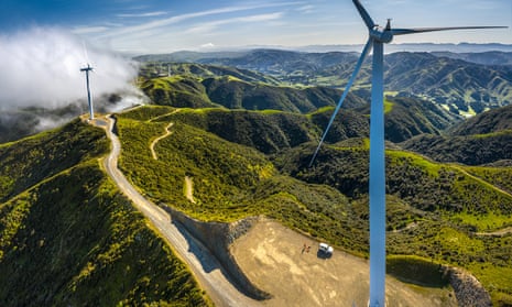 View over a valley showing wind turbines, showing the kiwi bird release area