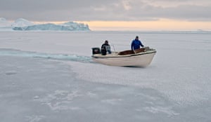 tiny motorboat on frozen sea