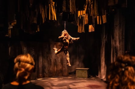 A dancer is suspended on a rope.