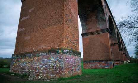 The columns of Twemlow Viaduct covered in chalk messages