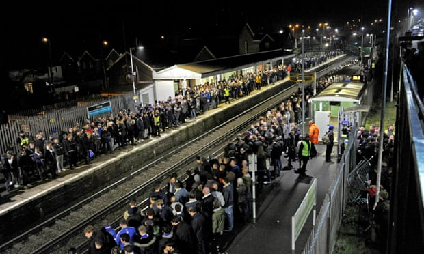 Football fans wait for trains at Falmer station near Brighton after a match. Disruption on the Southern network has left thousands of people with long waits 