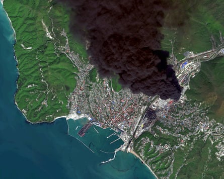 A satellite image of black smoke blowing across the urban area of Tuapse and surrounding green hills