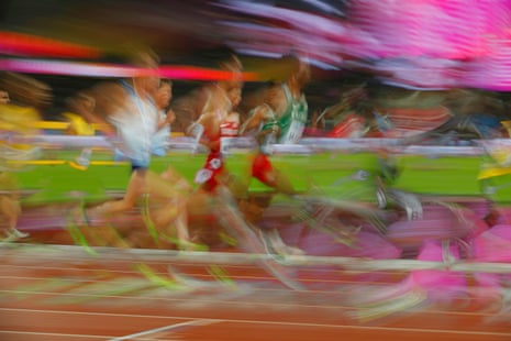 Athletes compete in a heat of the mens 5,000m.