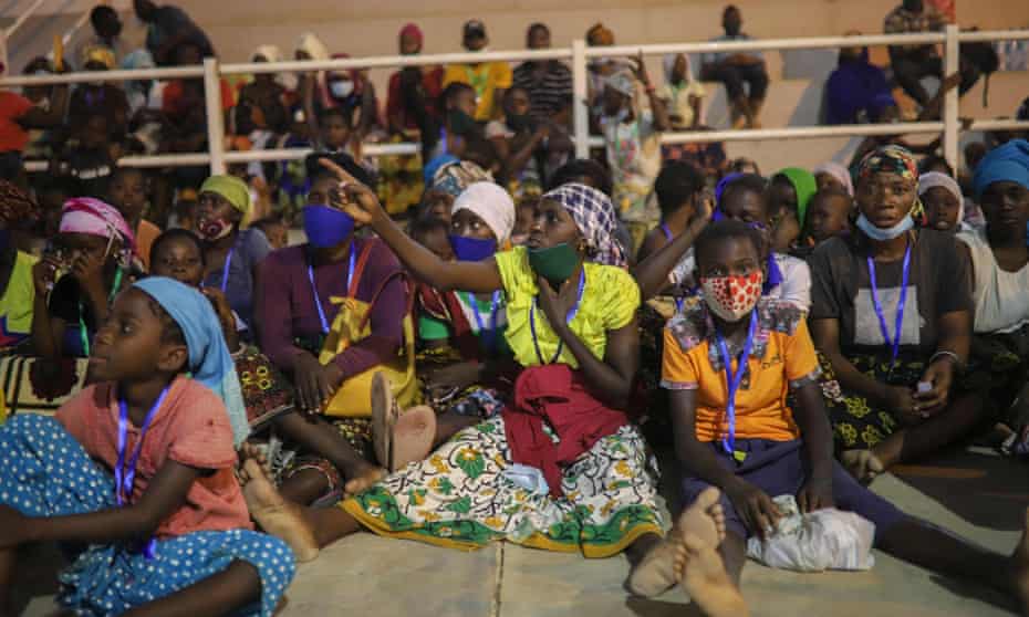 Internally displaced people from Palma gather in a sports centre in Pemba to receive humanitarian aid