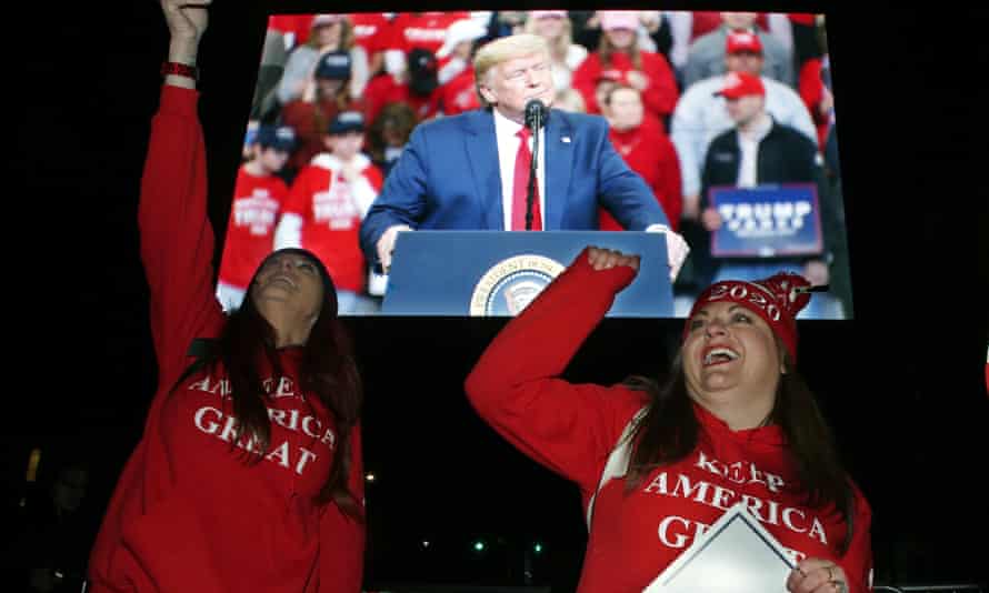 Trump supporters cheer during a live feed outside the rally.