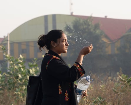 Neha splashes her face with water