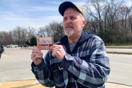 Christopher Romey holds a photo of himself by the Francis Scott Key Bridge in Baltimore in the 1980s.