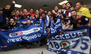 Blackburn Rovers’ squad celebrate promotion in the dressing room after the game at Doncaster