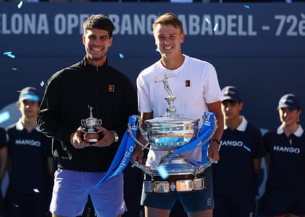 Holger Rune and Carlos Alcaraz hold their trophies after the final of the Barcelona Openin April.