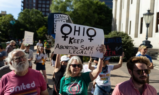 Woman holds sign saying 'Ohio - keep abortion safe and legal', during protest