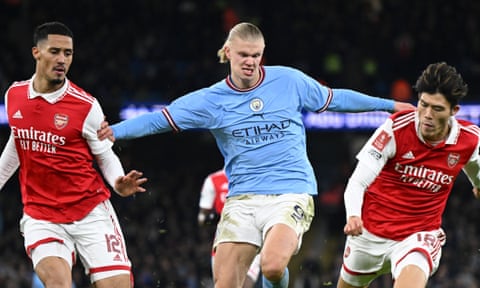 Erling Haaland holds off William Saliba and Takehiro Tomiyasu as Manchester City defeat Arsenal at the Emirates Stadium in February