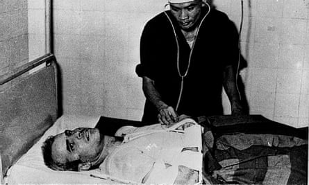 McCain is examined by a Vietnamese doctor after his capture in 1967 in Hanoi.