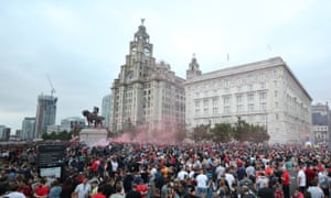 Liverpool fans let off flares outside the Liver Building as celebrations of the Premier League title win continued