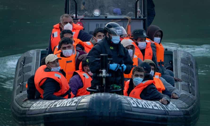 A group of people is brought to Dover, Kent, by Border Force officers.