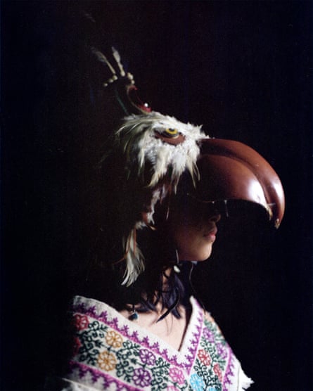 Yohualli Nikté Díaz poses in her house with her eagle costume, Cuetzalan del Progreso
