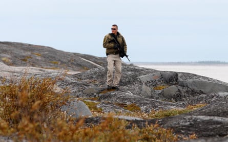 A member of the RCMP watches for polar bears at the Cape Merry National Historic Site in ChurchillA member of the Royal Canadian Mounted Police watches for polar bears at the Cape Merry National Historic Site in Churchill, Manitoba August 23, 2010 during a visit by Canada’s Prime Minister Stephen Harper.