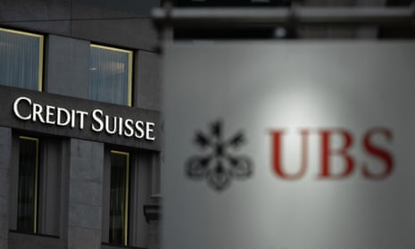 Credit Suisse sign behind one of Swiss bank UBS