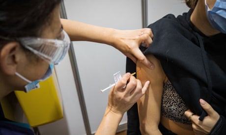 A woman receives the Pfizer vaccine at the Royal Exhibition Building vaccination centre in Melbourne