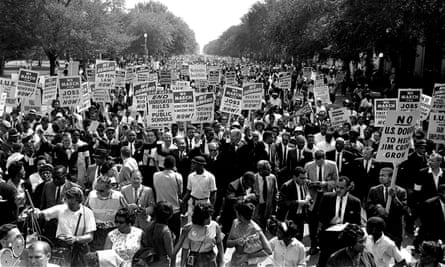 On 28 August 1963, Dr Martin Luther King Jr, center left with arms raised, marches along Constitution Avenue with other civil rights protestors.