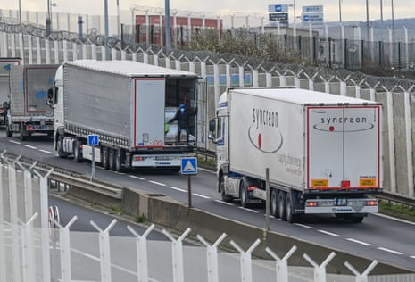 A migrant climbs into the back of a lorry bound for Britain
