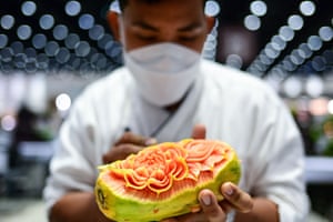 Bangkok, Thailand. A participant creates patterns in a papaya during a fruit and vegetable carving competition at the 26th Thailand International Culinary Cup