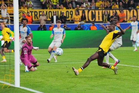 Dortmund's Serhou Guirassy (right) slides in to score the home side’s second.