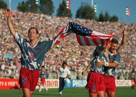 Thomas Dooley carries a US flag with teammates