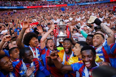Joel Ward lifts the trophy alongside teammates in front of the massed Palace fans after the FA Cup final victory over Manchester City.