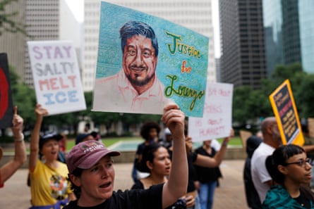 a person holds a sign that says ‘justice for Lorenzo’