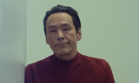 Portrait of man with green wall behind