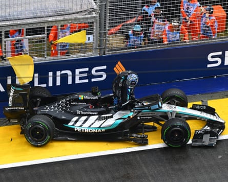Driver George Russell steps out of his car after crashing out of the sprint race in Singapore
