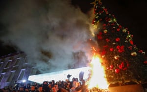 Coronavirus live news: Spain’s rate of confirmed cases at lowest level since August; Canada approves Pfizer vaccine | World news 2 Demonstrators set fire to a Christmas tree during a protest in reaction to the killing of Klodian Rasha.