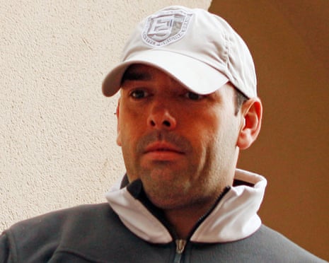 Daniel Kinahan, in a white cap and gray jacket, looks at the camera