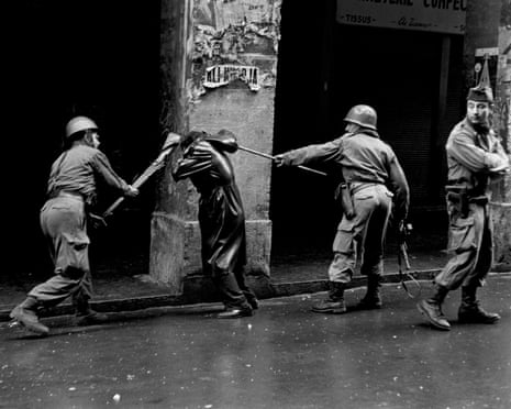 French troops beat an Algerian man