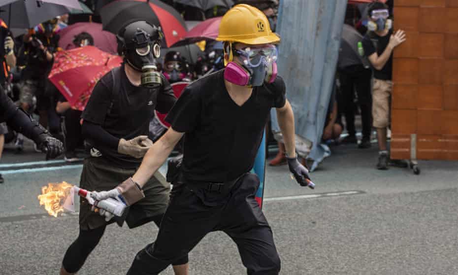 A protester gets ready to throw a molotov cocktail at the police during a rally in Hong Kong on Sunday.