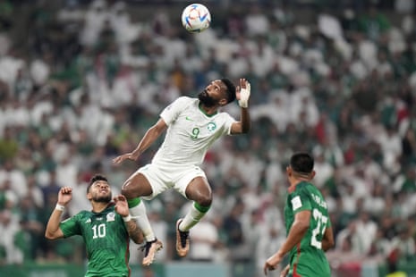Saudi Arabia v Mexico: World Cup 2022 – live | World Cup 2022 6 Mexico's Alexis Vega (left) and Jesus Gallardo (right) watch Saudi Arabia's Firas Al-Buraikan jumping for the ball.