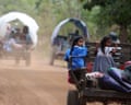 Girls sit behind a tractor as they are evacuated amid deadly clashes between Thailand and Cambodia.