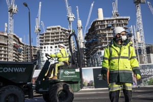 London, UK: construction workers wear masks and keep a distance from one another