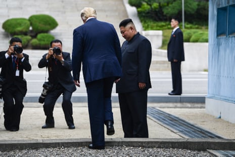 US President Donald Trump steps into the northern side of the Military Demarcation Line that divides North and South Korea, as North Korea’s leader Kim Jong Un looks on.