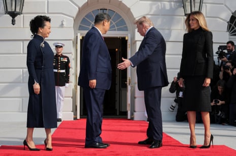 Trump and Xi on a red carpet flanked by their wives