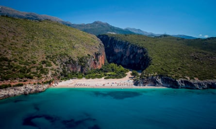 Adriatic beach in Albania surrounded by green hills where the Kala music festival is held.