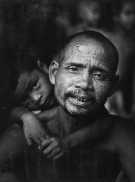 A man with a young child, both from one of the indigenous tribes of the central highlands of Vietnam