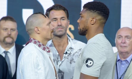 Eddie Hearn watches on as Oleksandr Usyk and Anthony Joshua stare off during the weigh-in