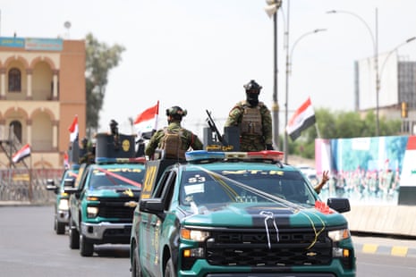 Iraqi security forces parade with their vehicles