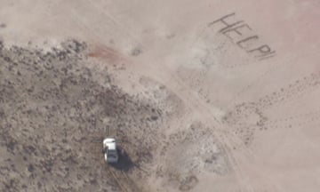aerial picture of sand with Help written in it