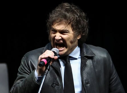 A grown emo-looking man screams into a microphone.