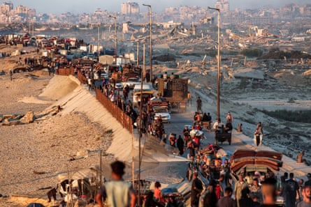 A crowded road of people traveling on foot and by cars